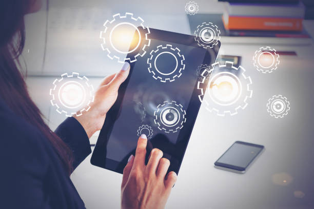 istock Woman working with tablet in office, gears 1183971118