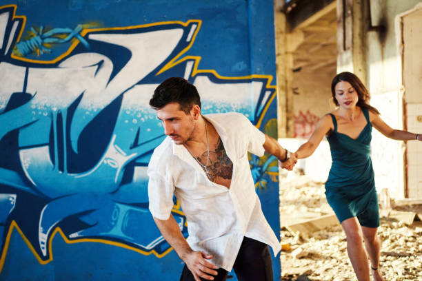 istock Young couple running to escape... 1183971285