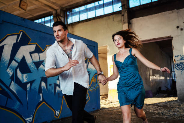 istock Young couple running to escape... 1183971292