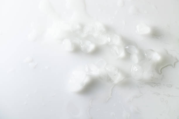 istock Melting ice cubes with water on white background. Overhand. 1183971503