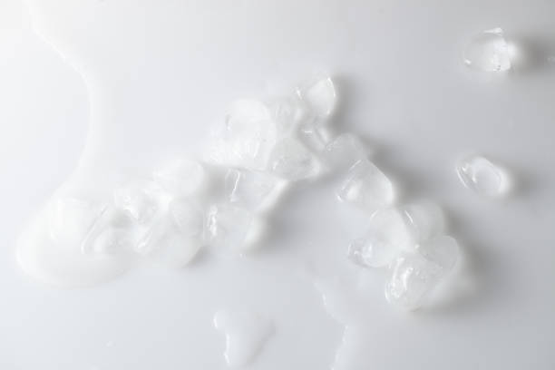 istock Melting ice cubes with water on white background. Overhand. 1183971537