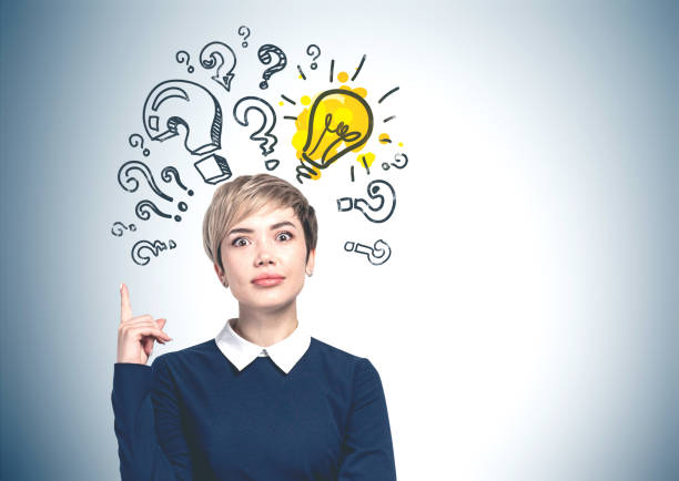 istock Woman pointing up, question marks and bulb 1183971554
