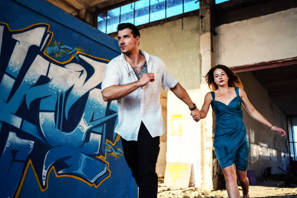Young couple running to escape...