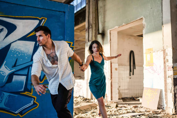 istock Young couple running to escape... 1183972386