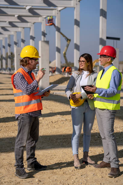 istock Construction Business Team Standing and Talking on Site Under Construction 1183972493