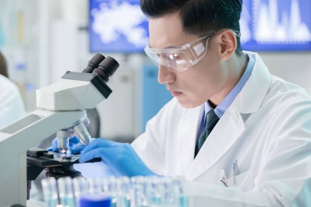 istock Asian male scientist use microscope 1183975026