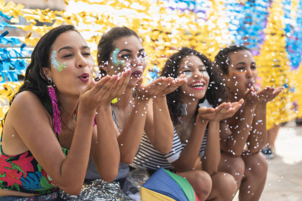 istock Women blowing confetti at the carnival 1183975345
