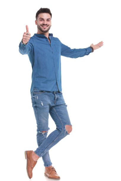 istock Handsome casual man giving a thumb up and presenting 1183975640