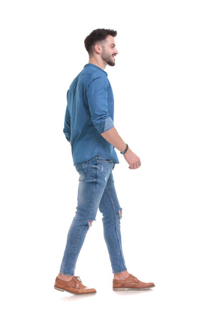 istock Side view of a happy casual man walking forward 1183975879
