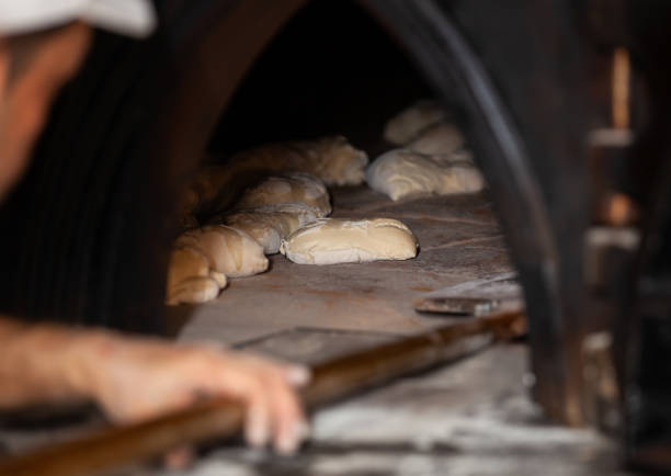 istock Close-Up Of Man Preparing Bread In Bakery 1183975938
