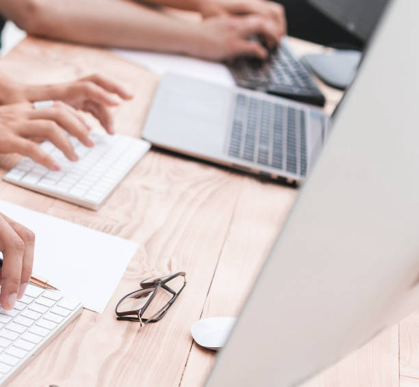 istock close up. the business team works on personal computers 1183976319