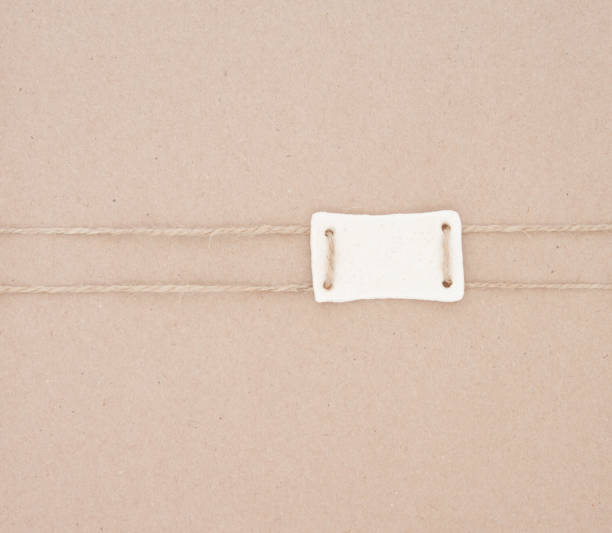 istock Cardboard packaging packed with jute and paper tag, label from the dough. Paper texture. Abstract background. 1183978246