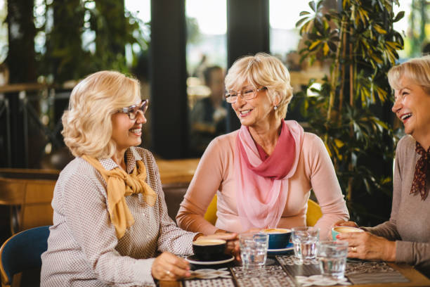istock Three senior ladies socializing over coffee in cafe 1183978268
