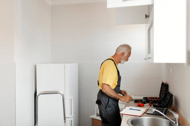 istock Senior Handyman Fixing Kitchen Cabinet 1183978295