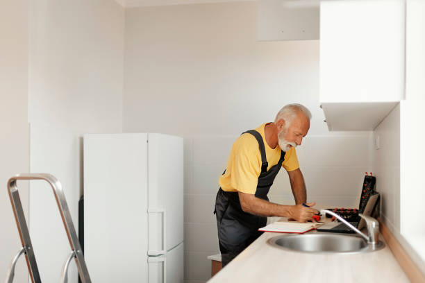 istock Senior Handyman Fixing Kitchen Cabinet 1183978298