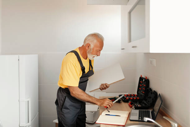 istock Senior Handyman Fixing Kitchen Cabinet 1183978353