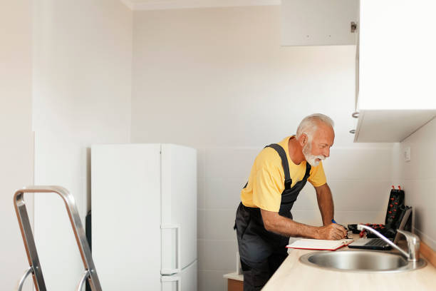 istock Senior Handyman Fixing Kitchen Cabinet 1183978925