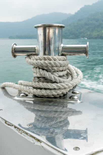 Mooring post on small boat on beautiful green water Mooring post on small boat on beautiful green water bollard pier water lake stock pictures, royalty-free photos & images