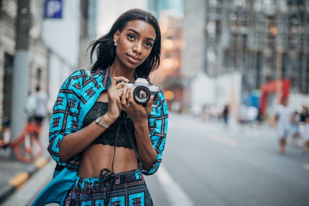 istock Black woman with camera 1183979123