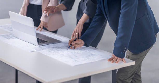 istock Business people discussing blueprint 1183980463