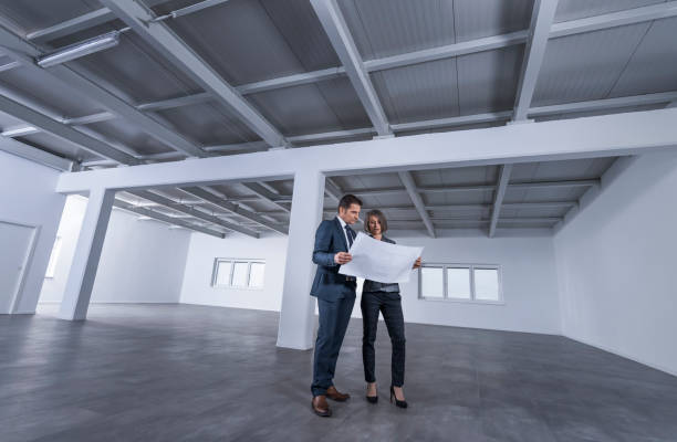 istock Business people discussing blueprint 1183980484
