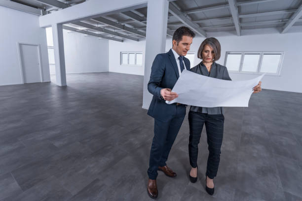 istock Business people discussing blueprint 1183980492