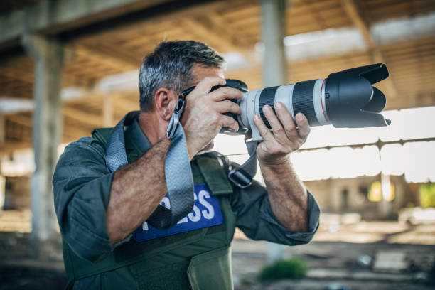 istock A war journalist moves through a war zone, taking photos from the scene 1183983206