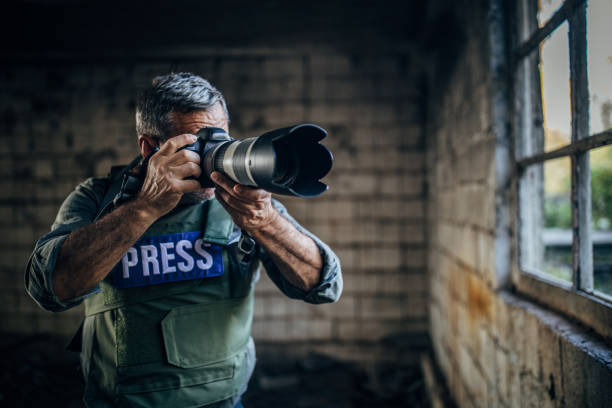 istock A war journalist moves through a war zone, taking photos from the scene 1183983361
