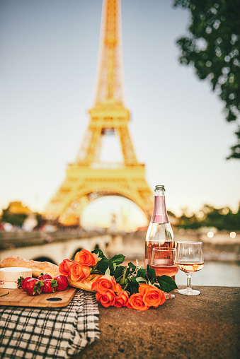 Still life shot of a romantic picnic setting outdoors in Paris with the Eiffel Tower in the background