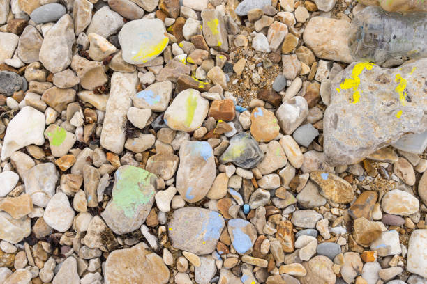 istock Pebbles with colored paint and crayons lying on a beach 1183988284