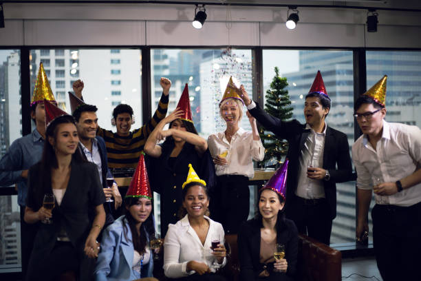 Close-up smiling Business people on New Year Party in Office and celebrating of New Year small group. Close-up smiling Business people on New Year Party in Office and celebrating of New Year small group. office parties stock pictures, royalty-free photos & images