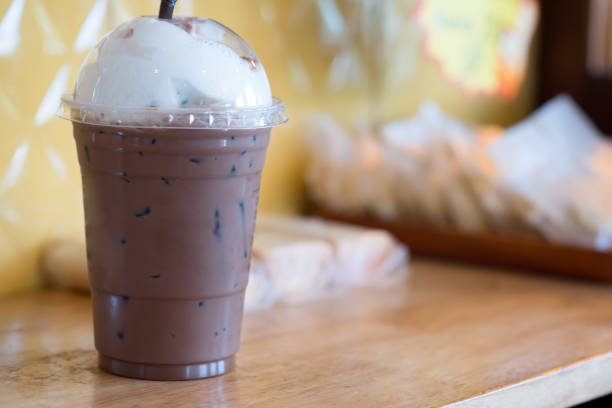 istock Iced coffee mocha in takeaway cup on wood table 1183991227