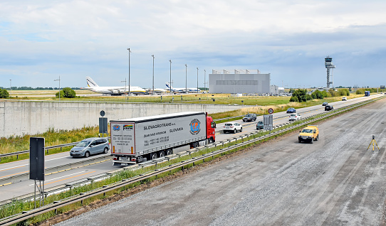Leipzig, Germany - July 13, 2016: The A14 motorway is closed on one side due to a construction site. The traffic is routed via the opposite side. In the background, huge Antonov cargo planes can be seen at Leipzig-Halle Airport (LEJ).