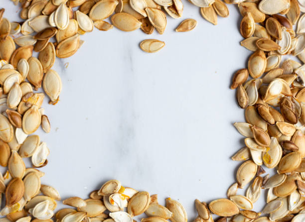 istock roast Pumpkin seeds background, flat lay 1183992597