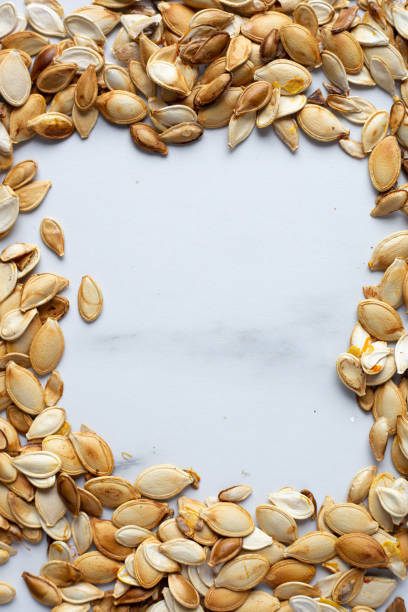 istock roast Pumpkin seeds background, flat lay 1183992618
