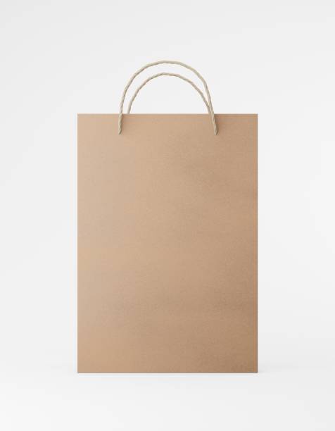 istock Eco packaging mockup bag kraft paper with handle front side. Standard medium brown template on white background promotional advertising. 3D rendering 1183992819