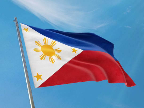 istock Philippines flag on a pole waving. Philippines  realistic flag waving against clean blue sky. 1183993526