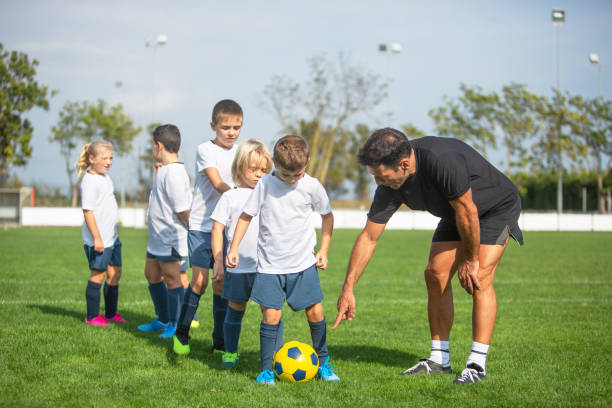 istock Young Footballers Practicing Ball Control with Coach 1183994085