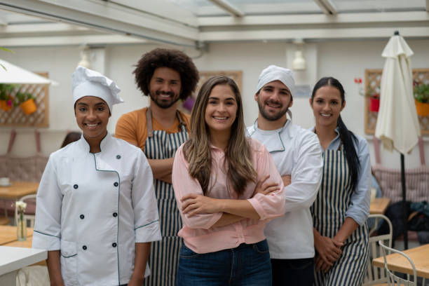 istock Business owner at a restaurant with her staff 1183994206