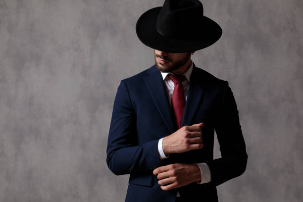 istock Attractive businessman adjusting his sleeve and looking to the side 1183994300