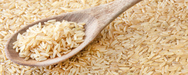 istock Whole grain rice and wooden spoon 1183995379