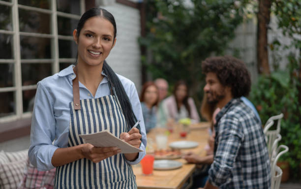 istock Latin American waitress working at a restaurant 1183995664