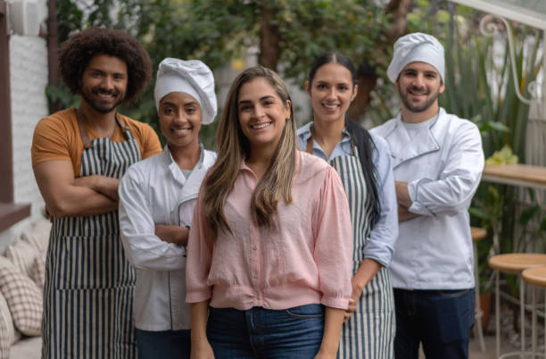 istock Business owner at a restaurant with a group of workers 1183995675