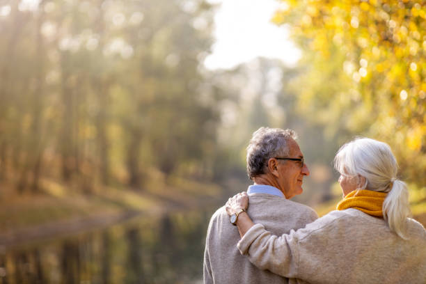 istock Happy senior couple in autumn park 1183995801