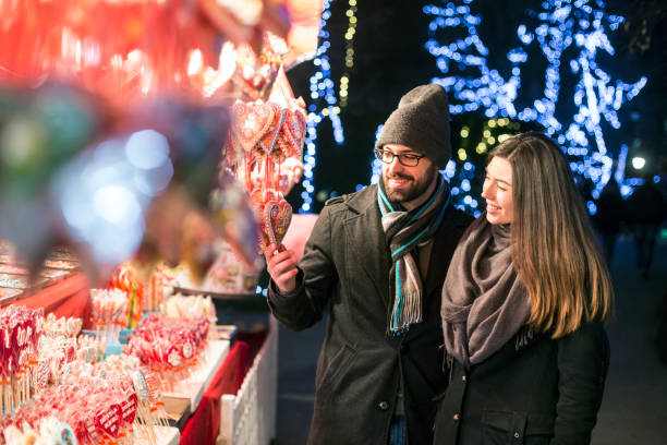 istock Young couple on a Christmas market 1183996502