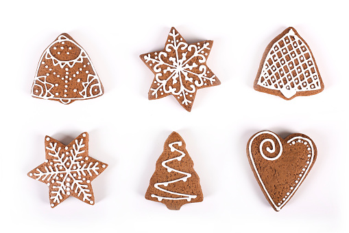 Group of various gingerbread cookies in different shapes - Christmas tree, star, bell, snowflake, heart etc. isolated on white background.