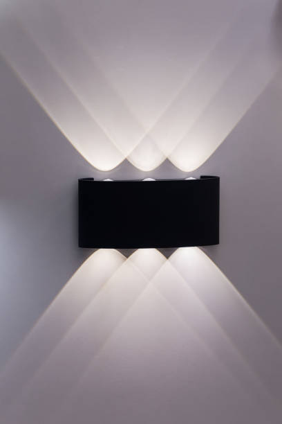 istock Modern ceiling wall lamp at home. Abstract interior background. Elements of interior. Reflections and shadows of lamp on the wall 1183998618
