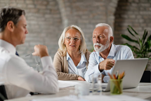 istock Senior couple talking with financial advisor while using laptop during the meeting. 1183999576