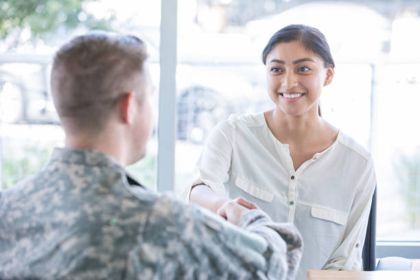 istock Army recruiter shakes young girls hand 1183999814