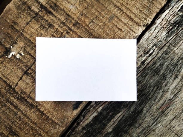 istock Blank paper on wood background 1183999902